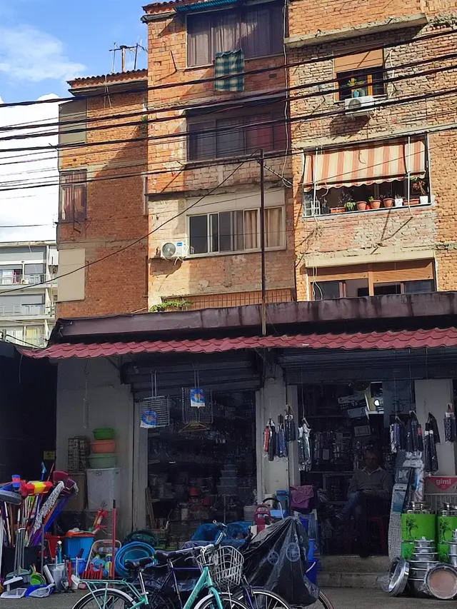 A neighbourhood corner shop in Tirana with bicycles parked outside