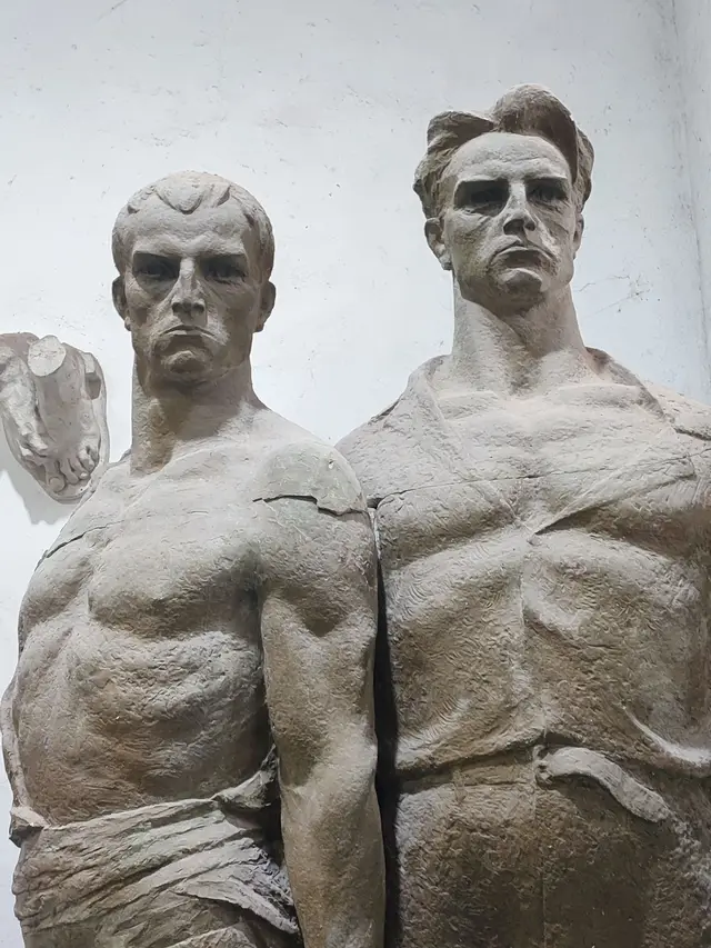Two socialist-realist partisan statues in a Tirana sculpture studio