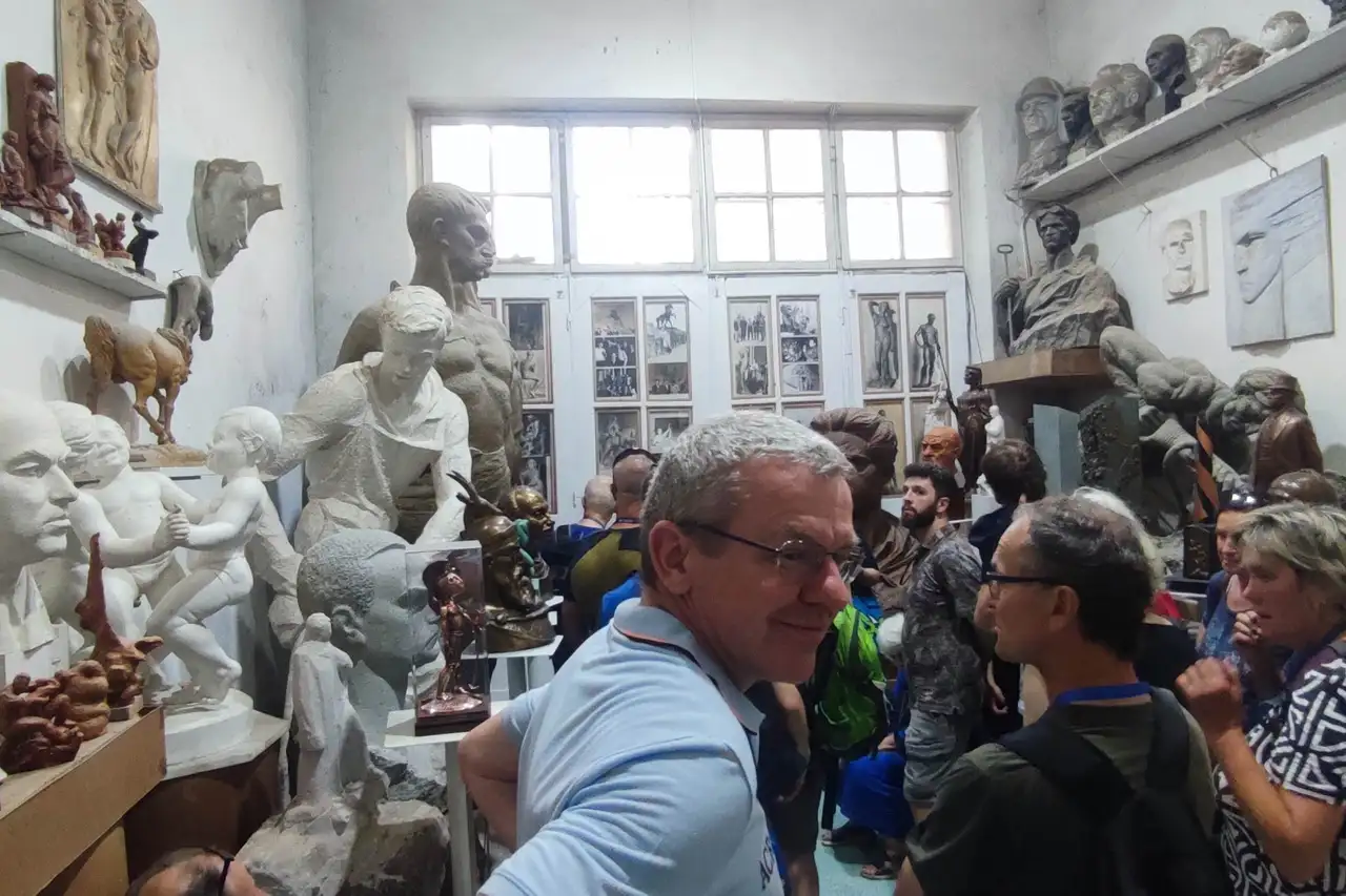 A tour group inside a sculptor's studio in Tirana